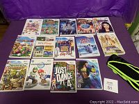Complete set of 14 Nintendo Wii game cases and discs, displayed with two extra Wii accessories (black and green straps). Clear image of all game titles and covers.