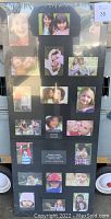 Full front view of large photo collage frame in black, showing multiple photo slots and decorative arrangement.