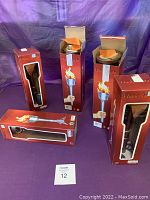 Five boxed battery operated flame lights arranged on a surface, showing original red packaging with flame torch image.