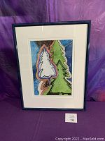 Full view of the painting showing stylized trees in green and white against a colorful abstract background, framed in dark blue with a white mat.