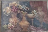Full front image of framed art print showing vases and flowers in muted colors with sculpted frame.
