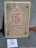 Front view of solid metal rectangular plaque with embossed Fess emblem, text and screw holes for mounting