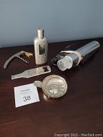 Photo showing all items: Electronic Wine Master SE corded wine opener, manual corkscrew, metal bottle opener, Chateau Meursault wine tasting dish, and seller lot number card.