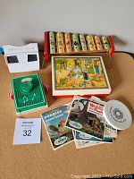 Vintage toys grouped on a table featuring a View-Master, wooden blocks in original case, Fisher-Price pocket radio, stereo picture reels, and wooden xylophone.