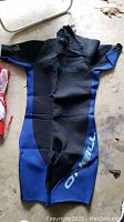 Photo of blue and black O'Neill wetsuit laid flat to show front detailing and size XXL