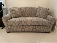 Front-facing view of loveseat showing overall shape and pattern.