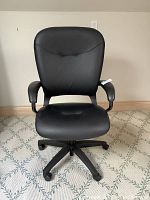 Front view of chair showing seat, backrest, armrests, and five-star caster base