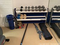 Overall view of Power One rack with dumbbells and accessories