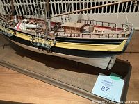 Close-up side view of hull and deck showing paint, rigging and deck cabin