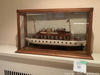 Front view of case displaying entire model yacht