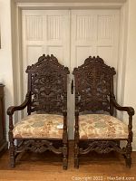 Front view of both chairs showing full carved backs and upholstered seats