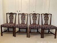 Front view of all four mahogany chairs in a row