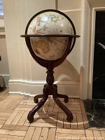 Front view of globe and wood stand