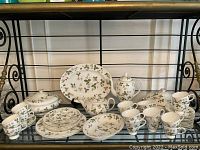 Full assortment of Wild Strawberry bone china set displayed on shelf