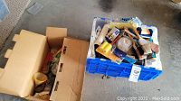 Box and bin with assorted painting tools including brushes, rollers and handles
