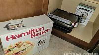 Tfal panini maker placed on kitchen countertop with Hamilton Beach panini press box and Cuisinart box in background