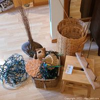 Overview of grouped assortment showing ceramic vase, various baskets, wooden stool and decorative items.