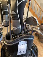 Close-up of club heads with covers, showing Cleveland Golf branding and visible club types