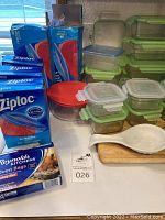 Photo showing assorted Ziploc freezer bags in blue packaging, Snapware glass storage containers with green and blue lids, white ceramic spoon rest, and Reynolds oven bags.