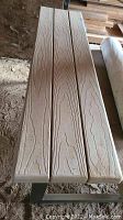 Close-up image of bench wooden plank seat showing wood grain texture.