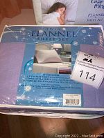 Photo of lavender twin flannel sheet set packaging with product details and label.