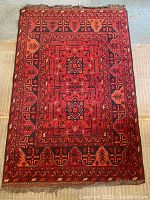 Overhead view of entire rug laid flat showing full pattern and overall condition