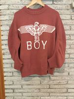 Full front view of coral Boy London sweater showing white eagle logo and BOY text on front.
