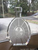 Front view showing crystal decanter shape with etched Remy Martin XO Special logo and text.