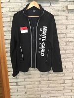 Front view of black zip-up jacket with Monte Carlo Monaco text and logo patch.