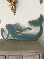 Full view of the painted metal mermaid wall art showing the entire mermaid shape and colors.
