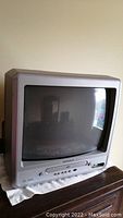 Front view of the Magnavox 13-inch TV/DVD combo showing the screen and control buttons below the screen.