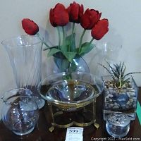 Full lot showing tall glass vase, round glass vase, medium glass vase, footed metal bowl with glass insert, faux succulent in square glass container, small silver decorative box.