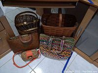 Photo showing all 5 items including large picnic basket, oval baskets, large handbag, multicolored tote, and small purse