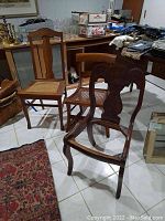 Three wooden chairs: one rocker and one slat-back with caned seats, and one smaller chair without seat. Medium wood finish. Scratches visible.