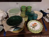 Full view of the collection showing plates, bowls, tumblers stacked and goblets in front