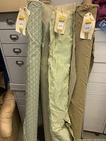 Four standing fabric bolts with visible price tags indicating high-end upholstery fabric from Sal Barresi Fabrics.