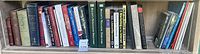 Shelf with 19 assorted books on various professional and business topics