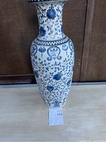 Full view of the Chinese porcelain floor vase showing blue floral patterns and a flared neck.