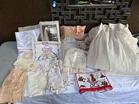 Overview of all items including pillowcases, crocheted pieces, and lace linens spread on surface.