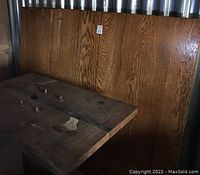 Photo of the drum-shaped golden oak pedestal base showing casters and connection points for the tabletop and leaves.