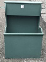 Front view of the shaker reproduction firewood box showing its deep cavity and flip lid container on top.