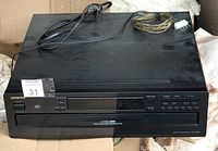 Front view of Onkyo party CD player showing model and control panel with cables laid on top.