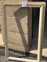 Front view of ornate wooden frame showing detailed carved white gold trim on edges.