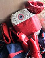 Red and white chest protector, red helmet, red hand and foot protectors together showing size M sparring gear.