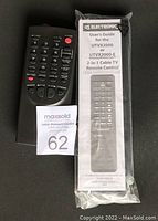 Black handheld remote control with numeric keypad and function buttons, and a sealed package containing a 2-in-1 cable TV remote control labeled UTVX2000 with user's guide.
