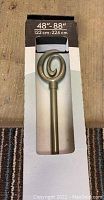 Photo of the decorative rod finial showing the circular swirl design and packaging length indication (48-88 inches).