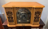Full frontal view of the Memorex phonograph showing wood finish and speaker grills on either side.