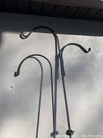 Photo showing the double and single arms at the top of the shepherd hooks with curved ends.