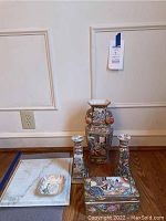 Photo showing full lot with Chinese porcelain vase, two candle sticks, decorative box, marble tray, and candy dish.