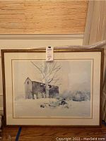Full view of framed artwork titled "Abandoned" depicting an old barn, tree, and abandoned car in snow.